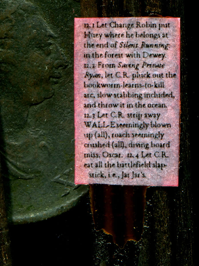 King George on a 1799 penny overlooks text stuck to four wooden stakes by a reddish-brown substance
